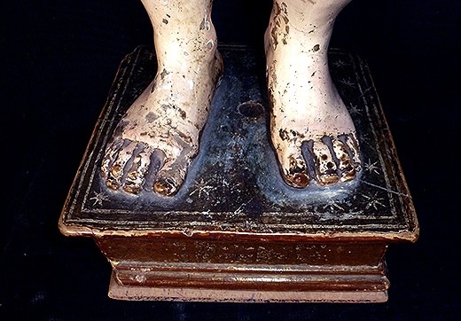 Los pies de la imagen antes de la restauración.